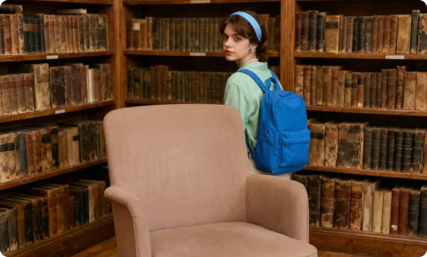 Una ragazza con uno zaino, in piedi rilassata vicino a una libreria e dietro una sedia. Mantieni ogni altro dettaglio della scena completamente invariato.